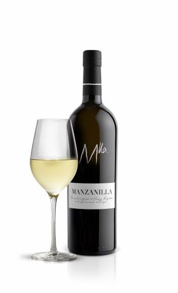 manzanilla bottle with a cup besides